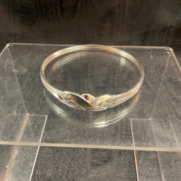 Close-up of a hallmarked silver bracelet with intricate detailing.