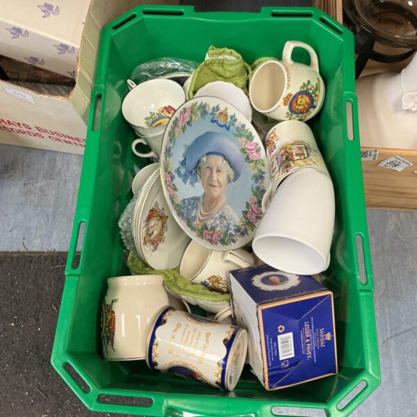 Vintage Royal Family memorabilia collection with china and portraits.