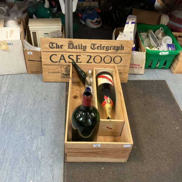 Vintage empty wine bottles with Daily Telegraph 2000 sign.