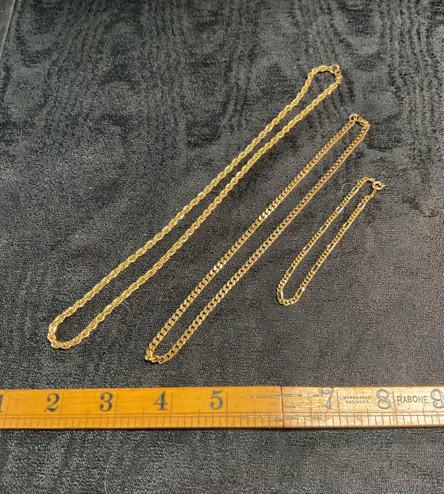 Two Yellowmetal necklaces and a bracelet