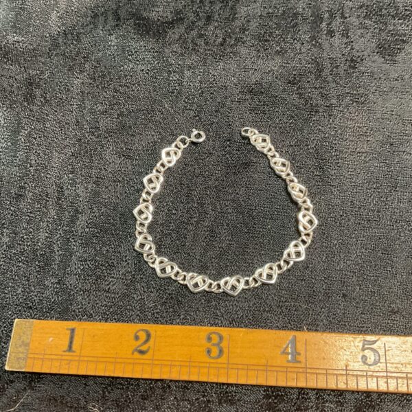 Hallmarked silver heart bracelet, vintage jewellery detail.