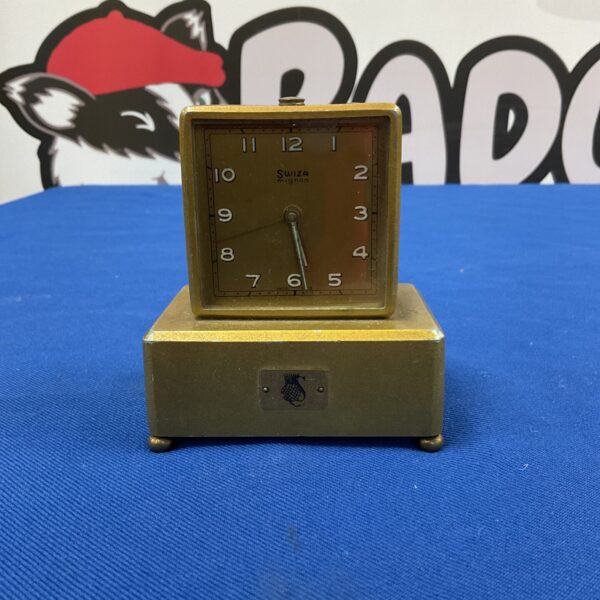 Vintage Swiza Mignon alarm clock with a round face.