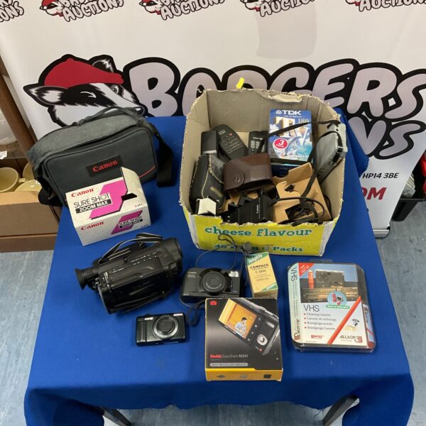 Vintage camera lot featuring Canon and Olympus cameras with TDK tapes.
