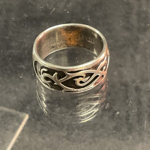 Intricate silver Celtic ring with knotwork design.
