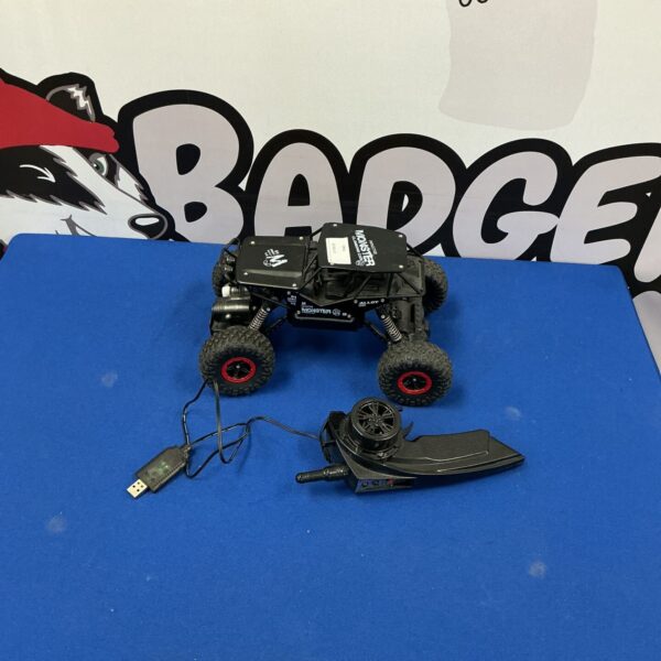 Side view of a monster remote control car with large tires.