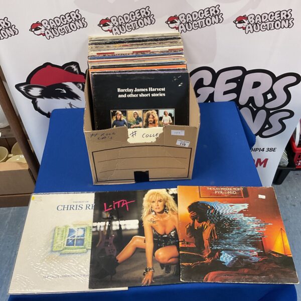 Collection of vintage rock LP records on a table.