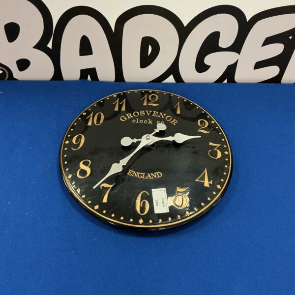 Vintage Grosvenor wall clock with bold numerals and hands.