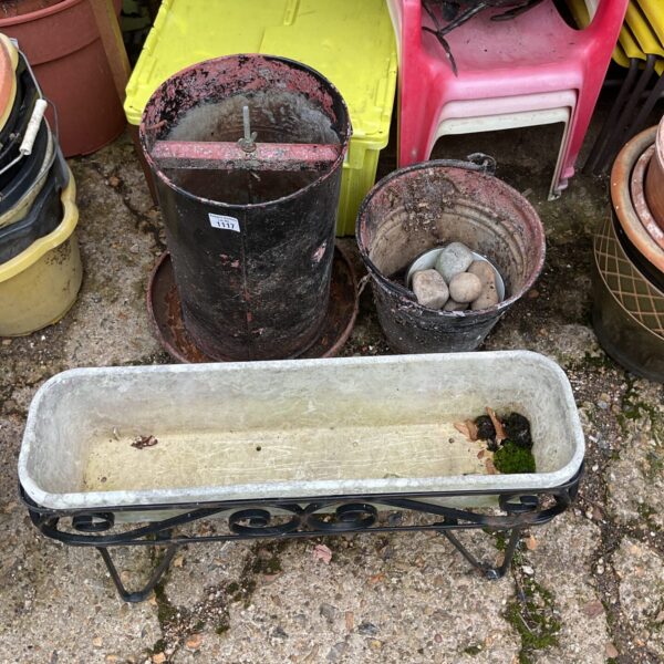 A vintage chicken feeder with galvanised bucket and trough planeter