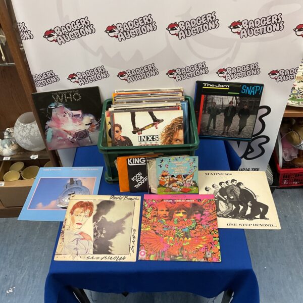 Vinyl record collection featuring David Bowie, Dire Straits, and Madness.