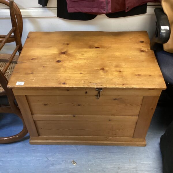 Large vintage pine trunk with a lift-top lid, ideal for storage.