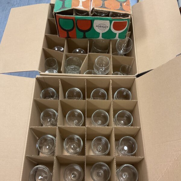 Large lot of Duralex wine glasses in cardboard boxes.