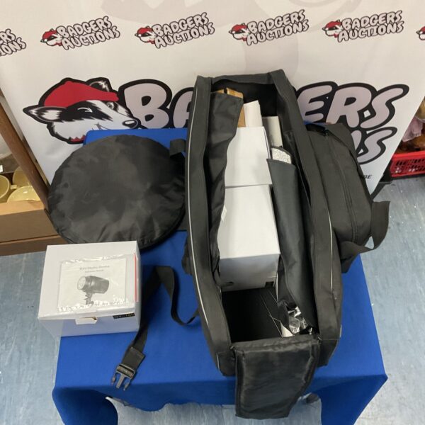 Black carry bag for a photography lighting kit.