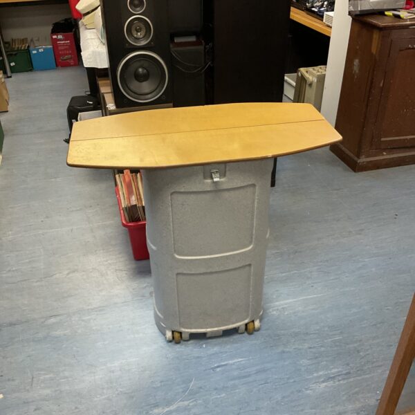 Portable event table with rolling base and wooden top.