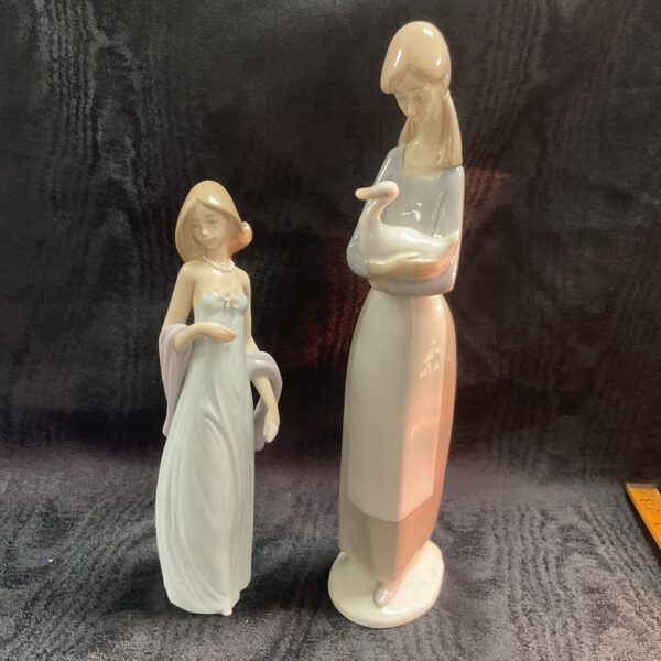 Lladro and NAO porcelain figures, a girl and a duck.