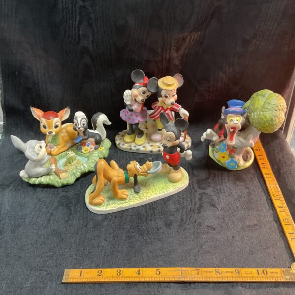 Vintage Disney ceramic figures including Mickey, Minnie, and Bambi.