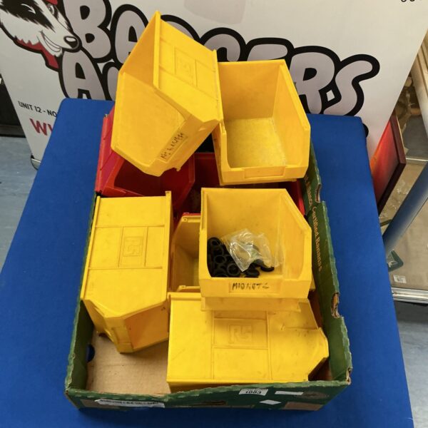 Bright yellow plastic tool trays for workshop storage.