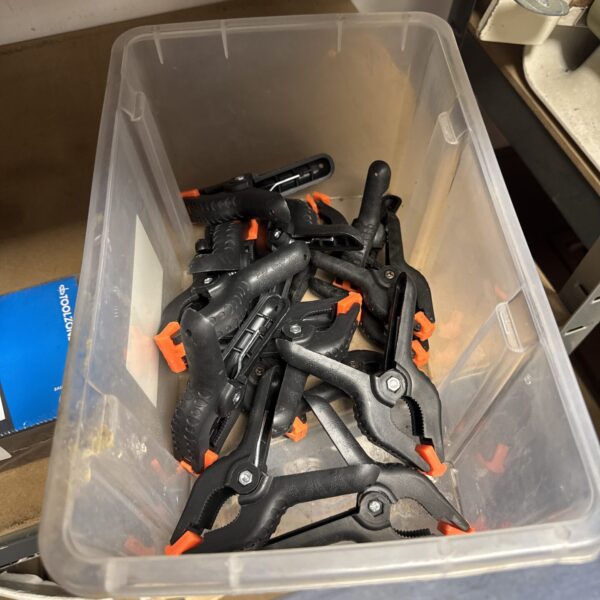 Bulk lot of plastic crocodile clips for crafting and DIY projects.