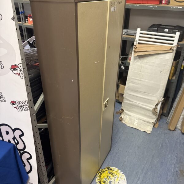 Vintage metal office shelving cabinet with "Sad Corner" label.