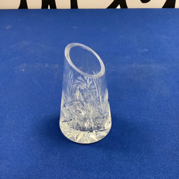 Delicate small crystal spill vase with intricate cut glass details.