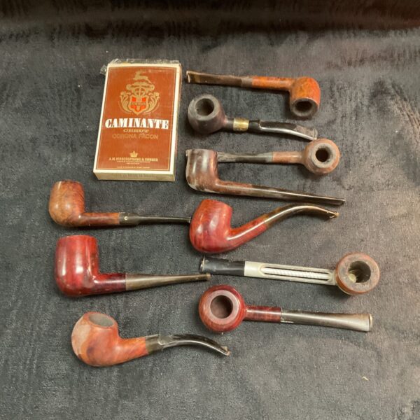 Vintage briar smoking pipes with a pack of Caminante cigars.