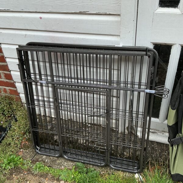 Metal folding pet cage for small animals.