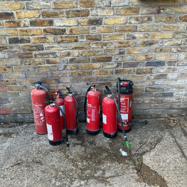 Bundle of fire extinguishers, some have contents