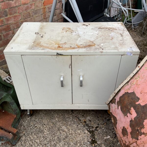 Front view of a vintage metal wheel cabinet.