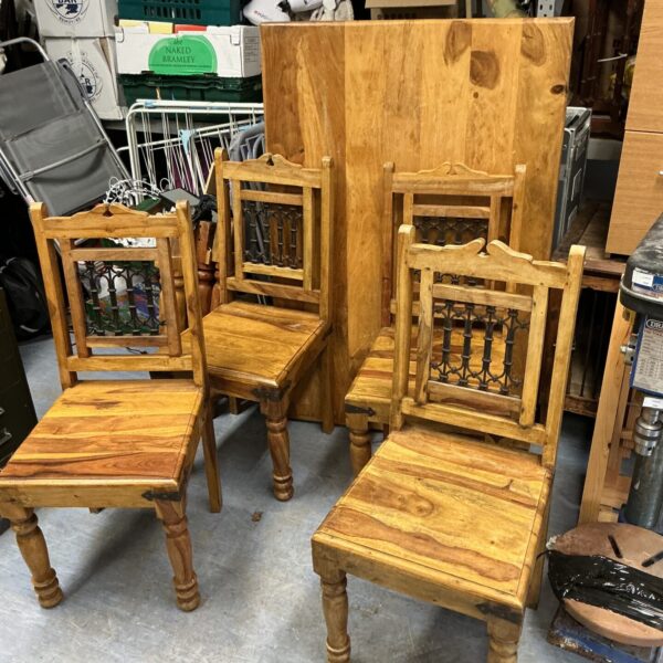 Chunky Indian oak dining table with four chairs and wrought iron panel backs