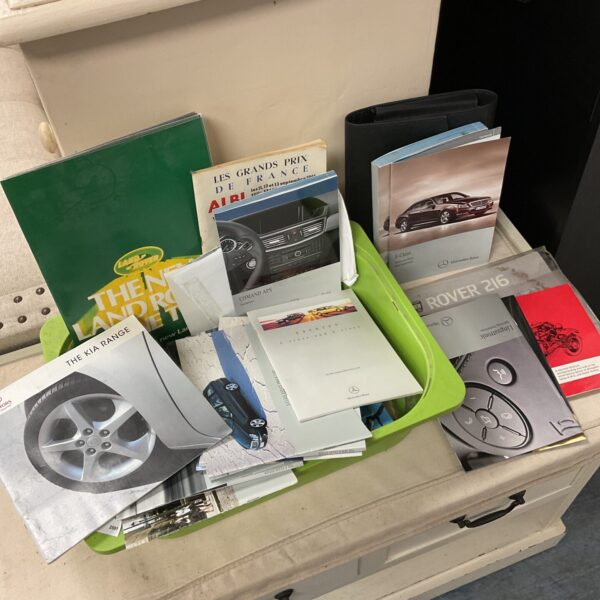 Collection of car owner’s manuals including Mercedes & land rover