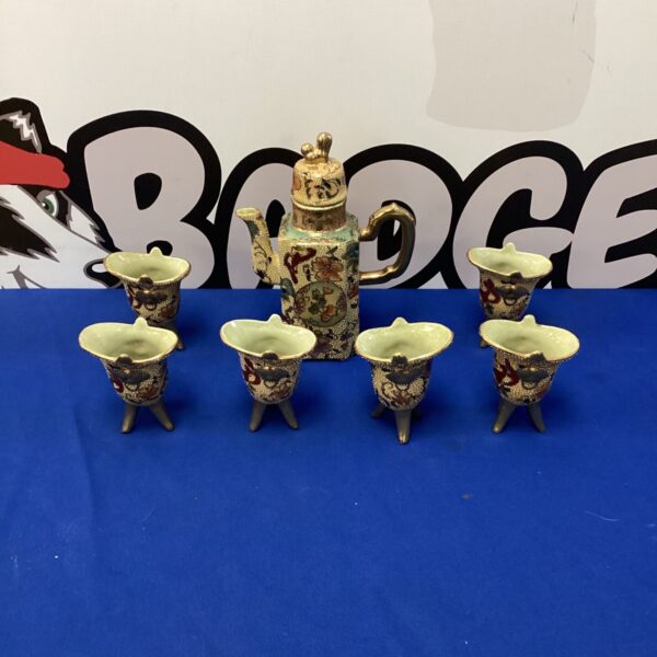 Vintage oriental tea service set with floral designs.