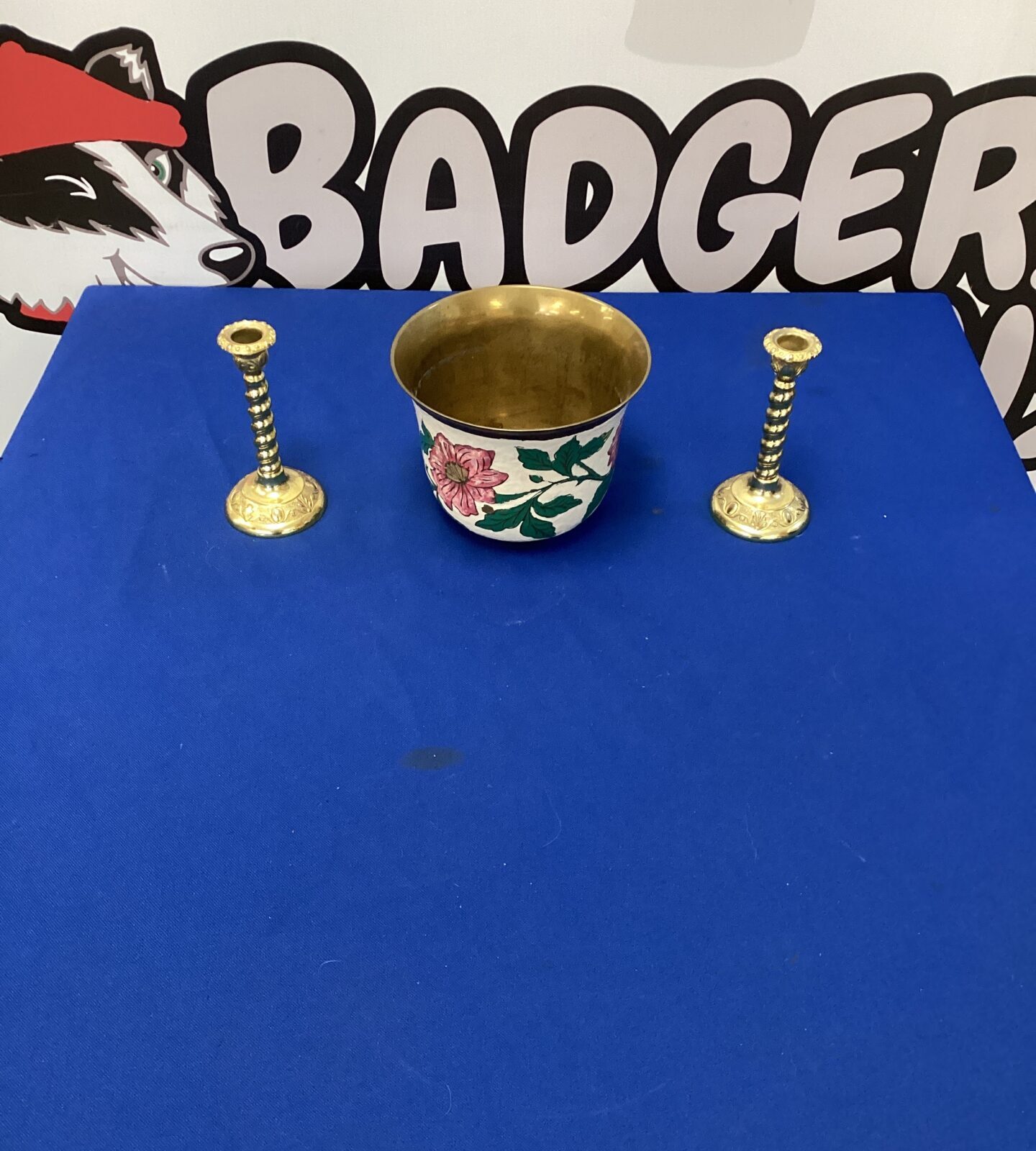Two gilded brass effect candlesticks with an indian brass pot
