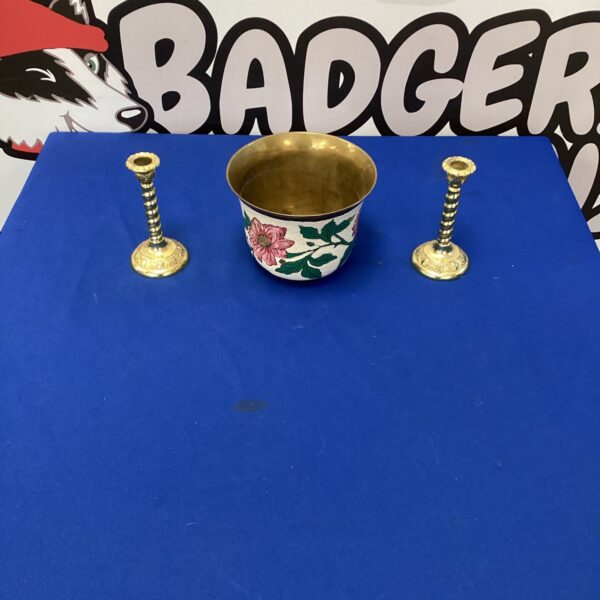 Two gilded brass effect candlesticks with an indian brass pot