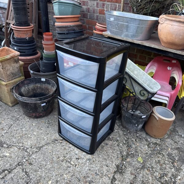 Black plastic storage cabinet with four drawers, ideal for home organisation.