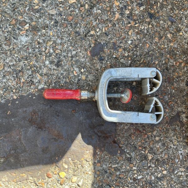 Kantenfix edge clamp resting on concrete surface.