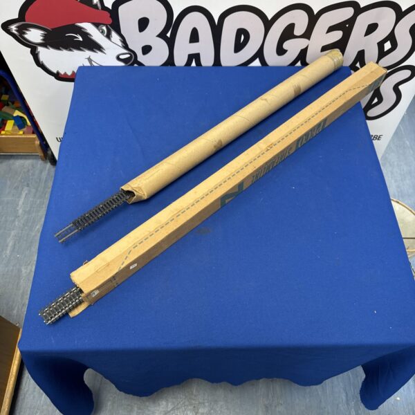 Model railway track sections on a blue table.