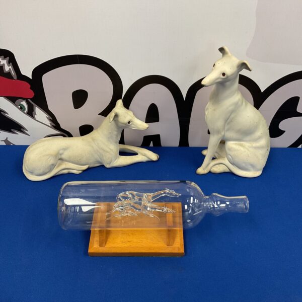 Two bisque porcelain greyhounds & racing greyhounds in a glass bottle