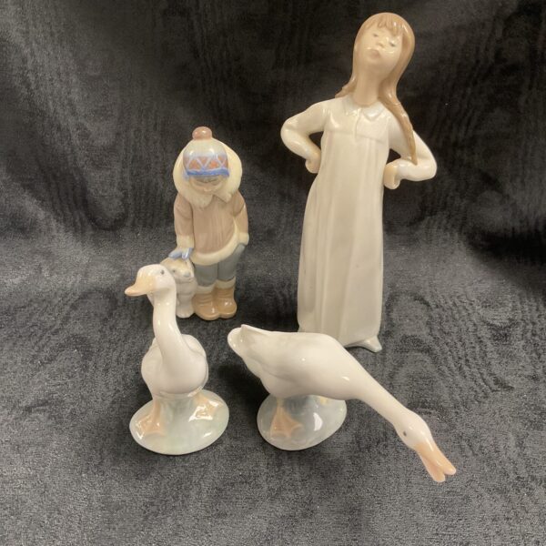 Group of four Lladro porcelain figures, vintage Spanish collectibles.