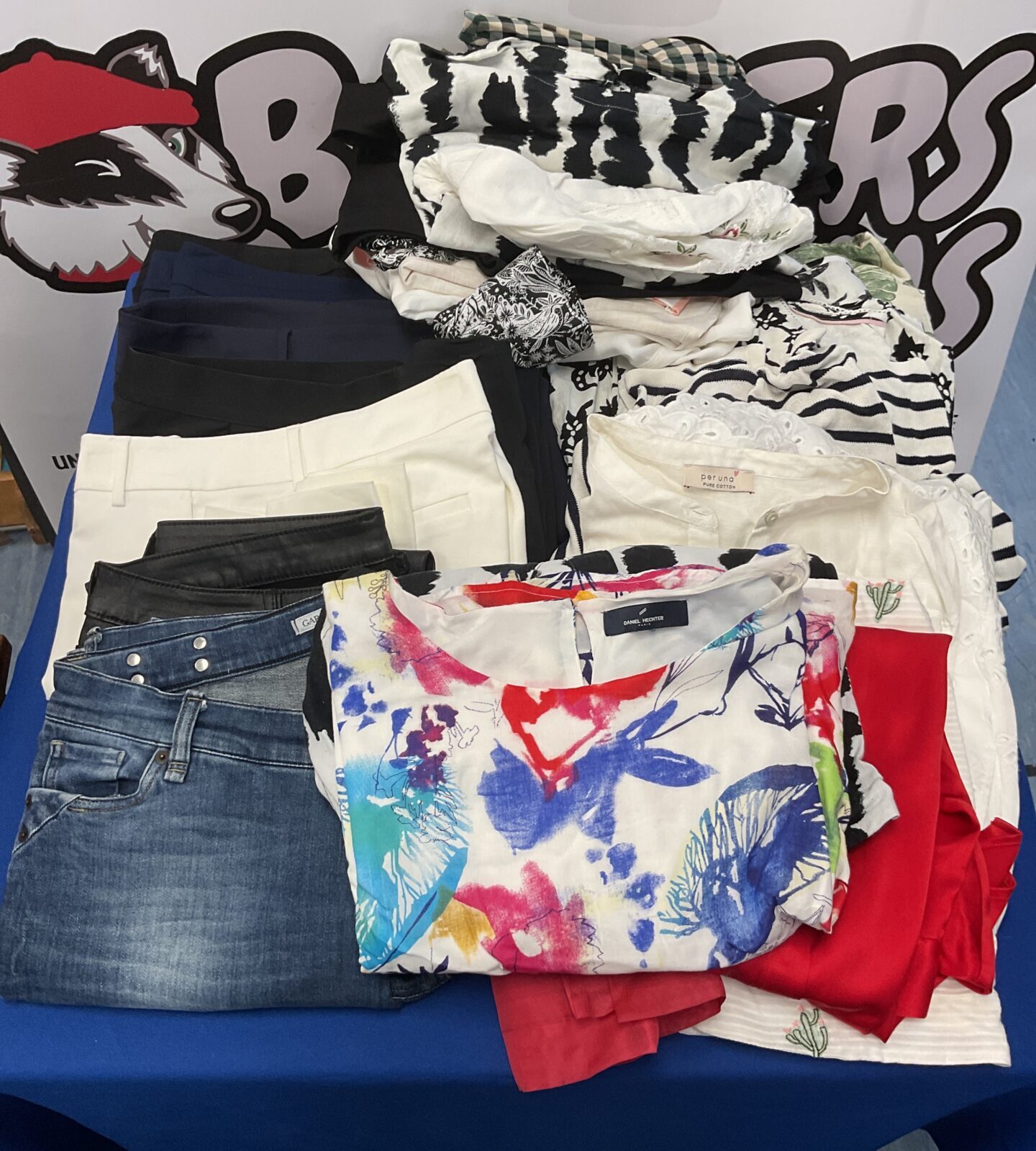 Two bags of clothes, dresses, tops, and trousers