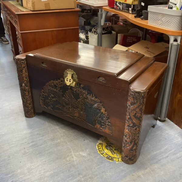 Intricate oriental carvings on a vintage camphor wood trunk.