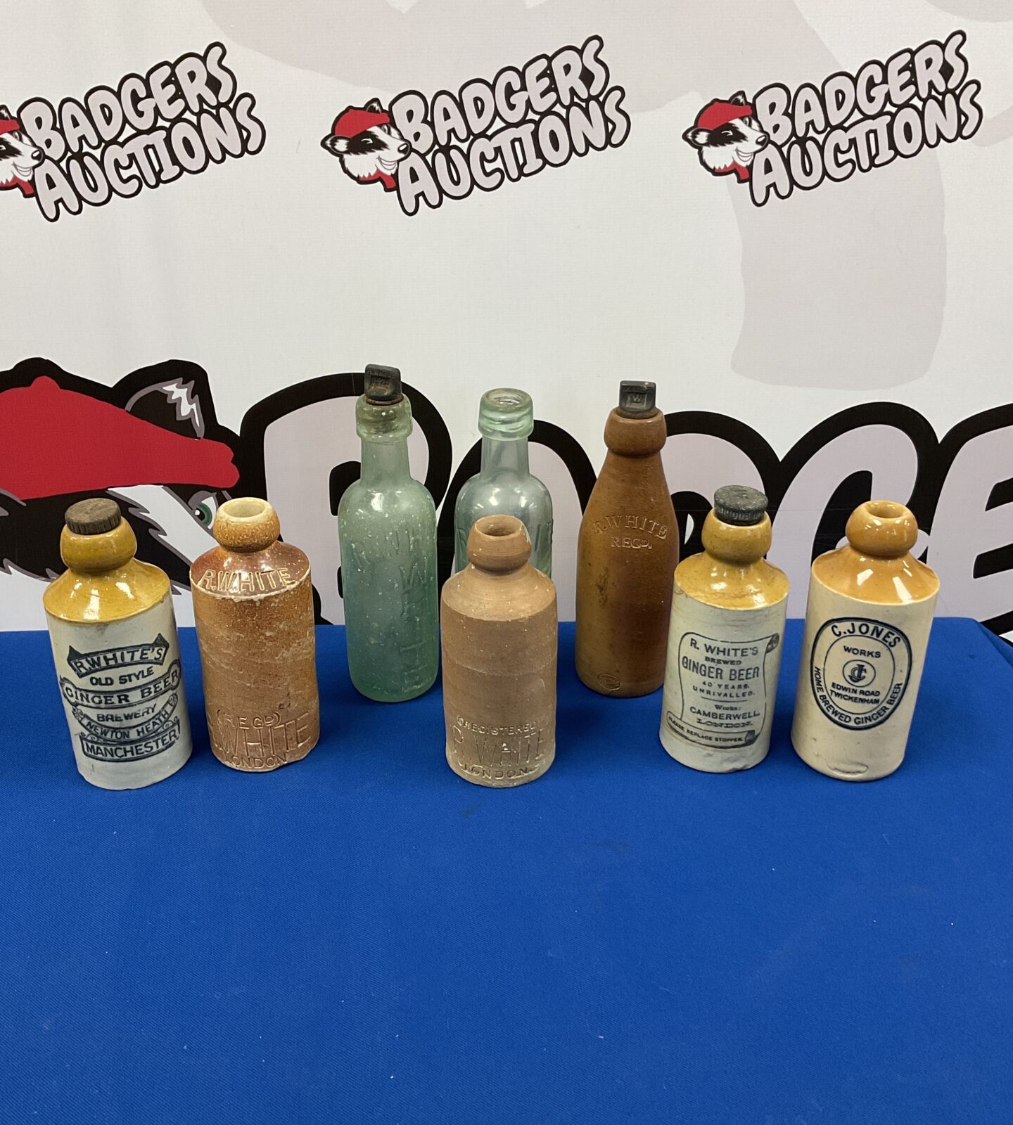 Collection of antique glass & salt glazed bottles including r whites & c jones