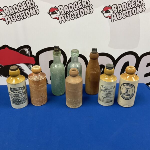 Collection of antique glass & salt glazed bottles including r whites & c jones