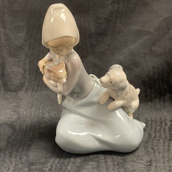 Lladro Little Friskies figurine with a girl and puppies.