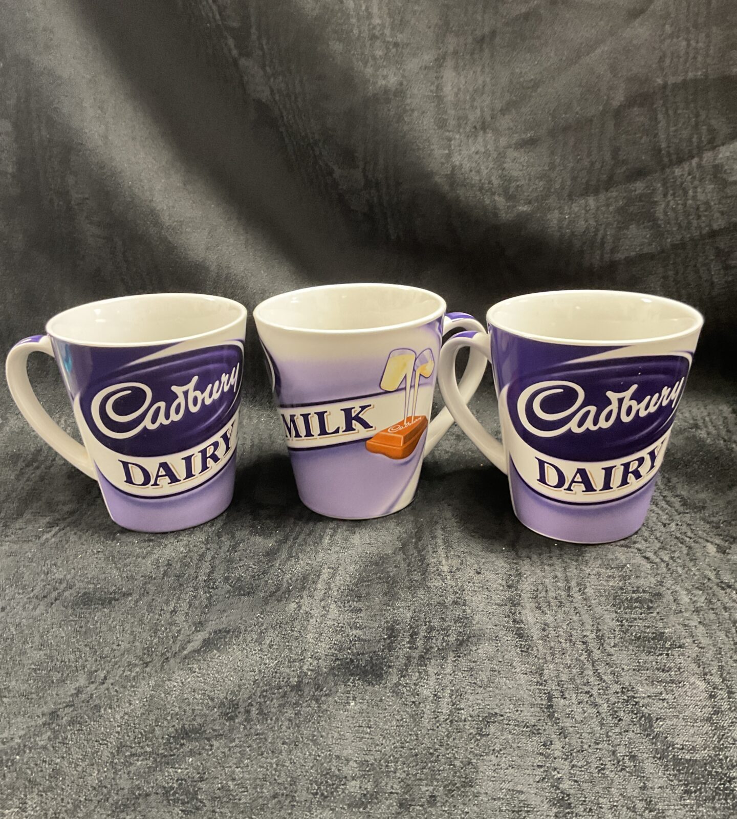 Three Cadbury dairy milk mugs
