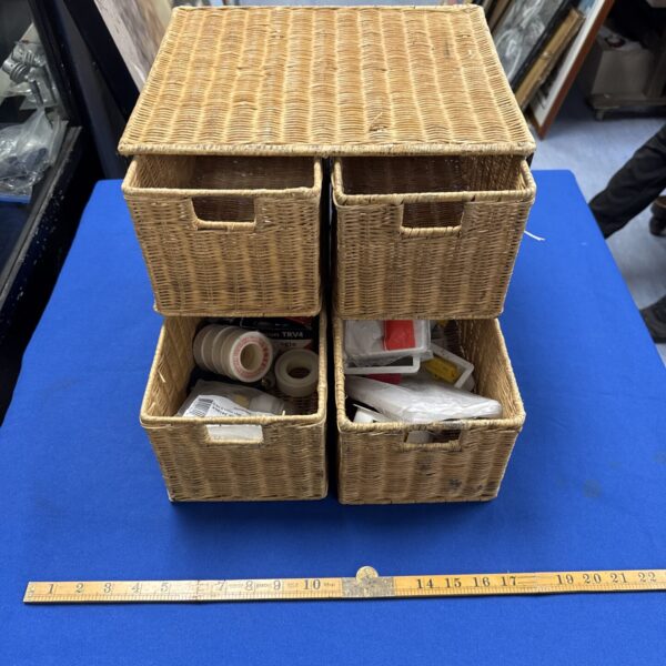 Vintage wicker storage cabinet with contents, rustic farmhouse style.