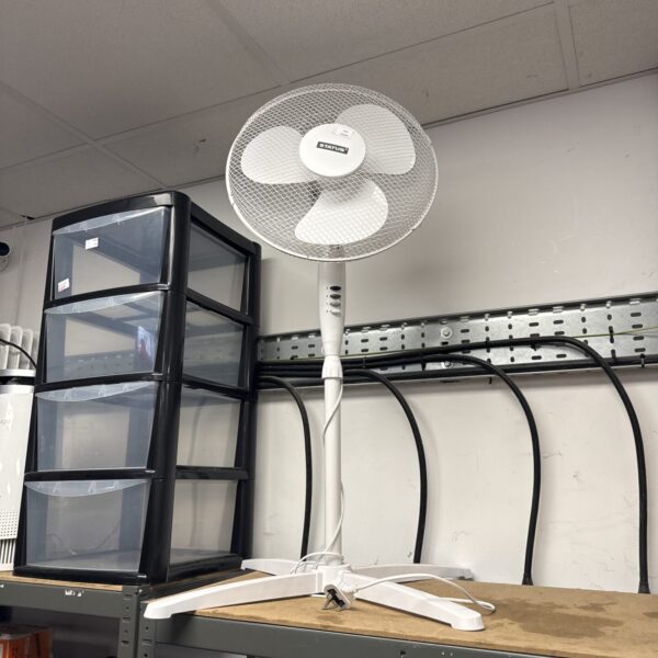 Vintage Status pedestal fan with metal base and adjustable height.