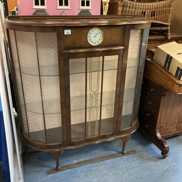Vintage mid century display cabinet with clock, showcasing retro style.