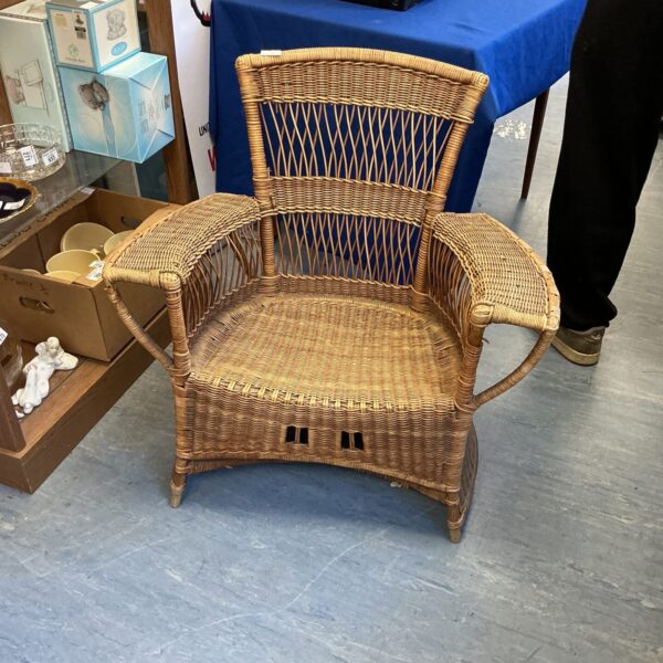 Vintage wicker armchair with woven rattan, ideal for retro decor.