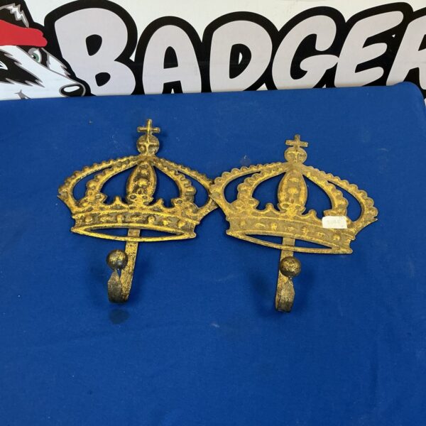 Pair of vintage copper crown coat hooks for wall mounting.