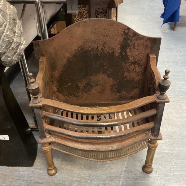 Antique cast iron fireplace grate with urn finials.