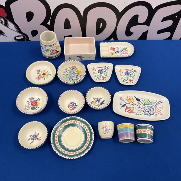 Vintage Devon pottery collection featuring floral patterned dishes and bowls.